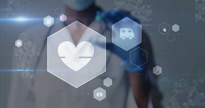 Interacting doctor wearing stethoscope and blue gloves selecting heart icon on hex HUD in hospital