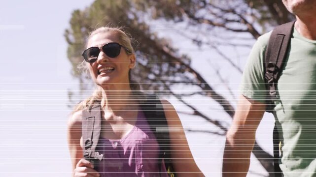Couple holding hands walking for travel cam tilting as glitch lines passing revealing smiles, packs