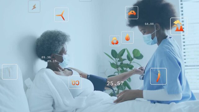 Nurse placing BP cuff on patient bed using monitor capturing BP with animated health readouts