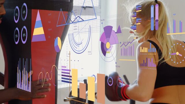 Female trainee throwing jabs at freestanding bag after trainer cue, boxing charts overlaid tracking