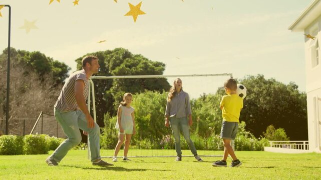Son tossing soccer ball, dad intercepting while yellow stars appearing and drifting for sports