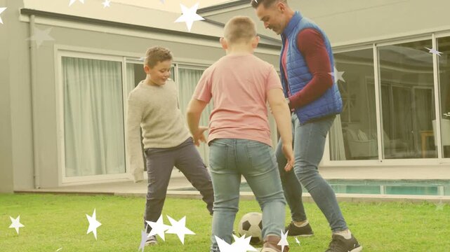 Father moving toward soccer ball, teaching boys footwork on lawn for health, star overlay floating