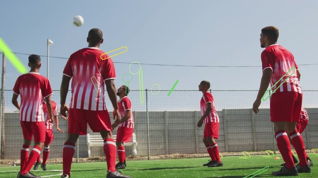 Sports team tracking incoming soccer ball on turf, green overlays sweeping players showing control