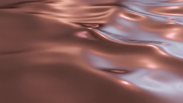 Closeup of liquid copper or molten metal surface with smooth ripples and soft reflections