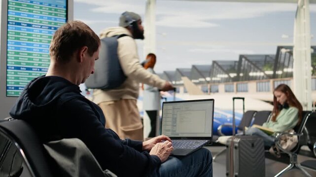 IT engineer creating scripts and managing databases for web platform while waiting for boarding in airport lounge. Emphasizes cloud computing via location independent flexible job.
