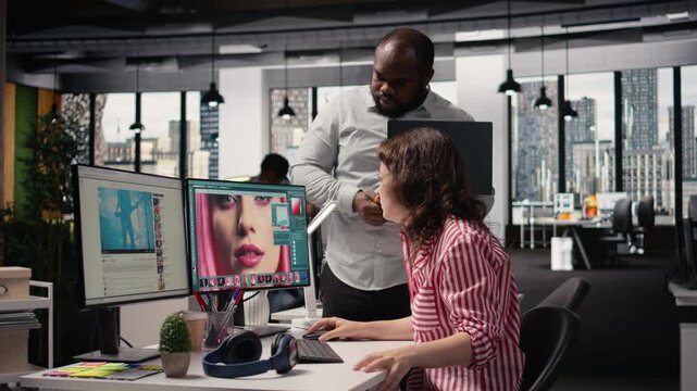 Creative designers team working on image editing and retouching with software on PC, color correction for editorial post production in agency office. Artistic tasks for catalog materials.