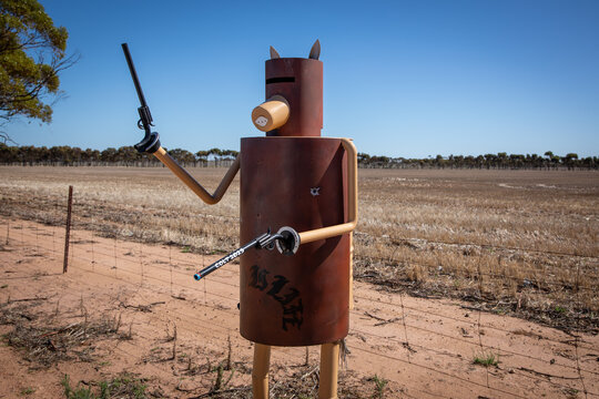 Metal Sculpture Holding Pistols Desert Landscape Ned Kelly