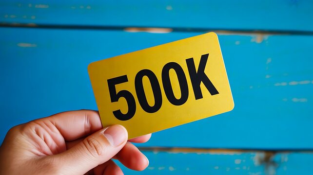 Five hundred thousand milestone card in hand background