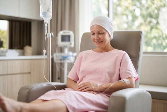 Smiling woman patient receiving chemotherapy treatment in a hospital
