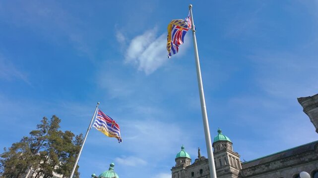 Victoria, BC, Canada &ndash; April 24, 2026: British Columbia Flags Waving at Parliament Buildings