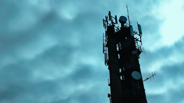 Silhouette of Telecommunication Tower Against Moody Sky