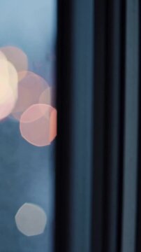 Blurred city lights and reflective rain, Moody urban view with raindappled reflective glass surfaces, Atmospheric cityscape where rainstreaked windows mirror dimmer lights and evening hues