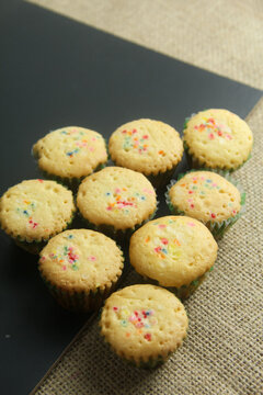 Photograph showcases a neat arrangement of miniature festive cupcakes, often referred to as Kue Cubit or similar traditional Southeast Asian treats typically served during Eid al-Fitr (Lebaran)