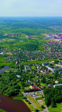 Vertical video. Veliky Novgorod, Russia. Novgorod Kremlin (Detinets), Volkhov River. Flight over the city. Drone footage. Rich colors