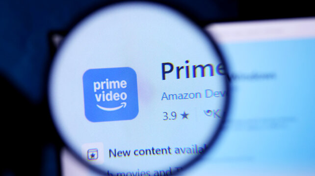 Magnifying glass showing amazon prime video app on a screen closeup