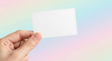 Fototapeta premium Hand Holding Blank White Business Card Mockup on Pastel Gradient Background
