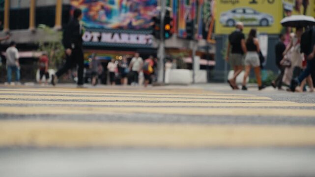 Low angle view of people crossing a busy street