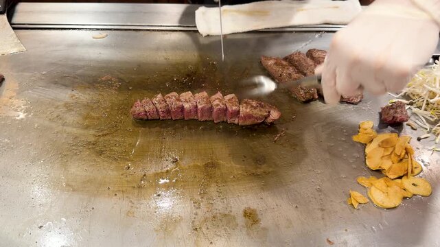 Barbecue meat on the grill. Grill chef searing steak on an open flame grill