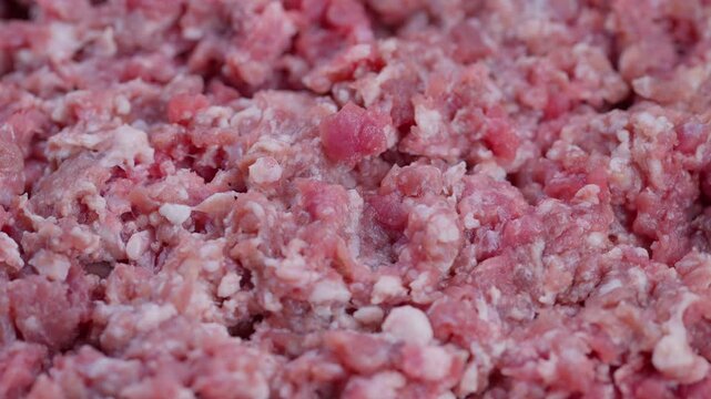 Meaty texture detail, Closeup of raw beef flecks, Raw minced meat with visible fat and grains, Highresolution macro image of fresh ground beef with fat and moisture