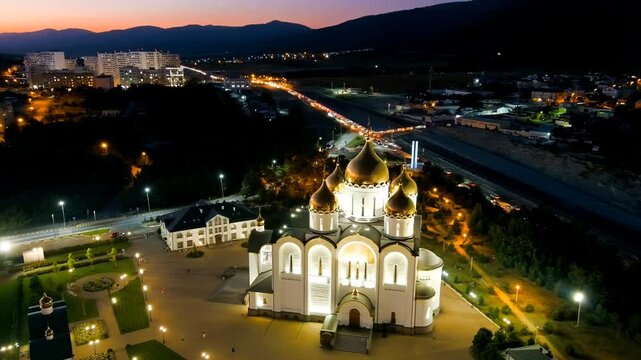 Gelendzhik, Russia. Cathedral of St. Andrew the First-Called. Andreevsky park. Night time. Drone footage, Departure of the camera