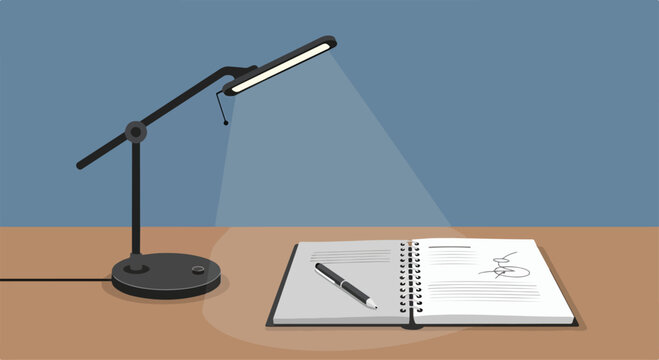 A desk lamp shining on a notebook and pen