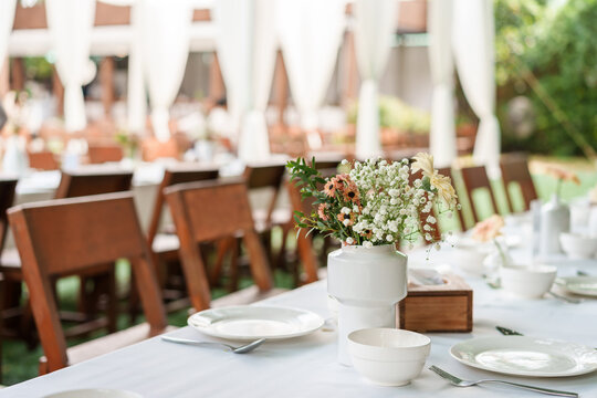 Outdoor wedding dinner table reception in romantic garden wedding atmosphere