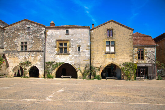 Historic stone house facades and arched porticos in Monpazier France