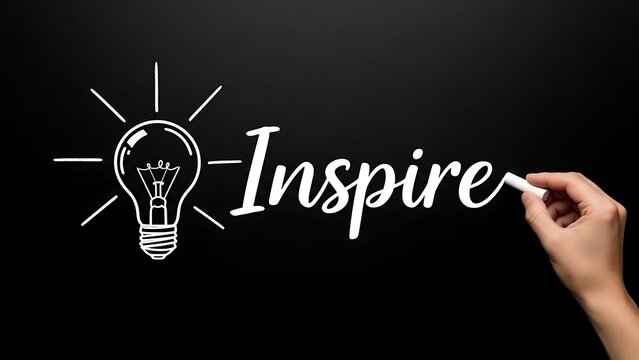 Hand writing inspire with lightbulb on blackboard, creative idea concept