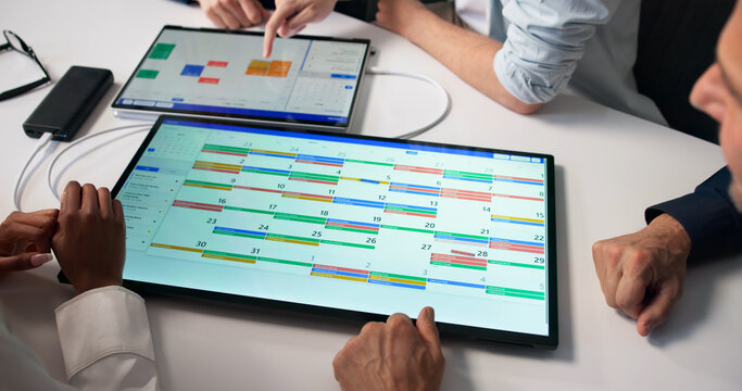 Project Manager Leads Diverse Team In Agile Meeting Using Kanban Board