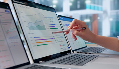 Naklejka premium Young Sales Manager Studies Pipeline Data On Laptop