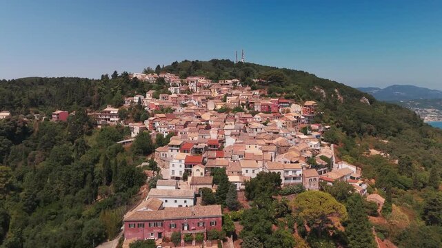 Low Aerial Drone Flight Over Terracotta Rooftops of Chlomos Village in Corfu Greece