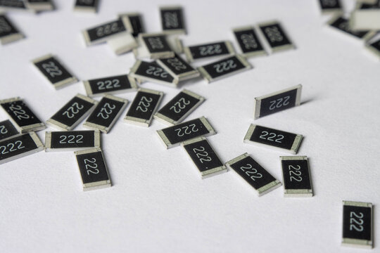 Surface mount resistors 222 scattered on white background