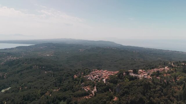 High Altitude Drone Approach of Chlomos Hilltop Village in Southern Corfu Greece