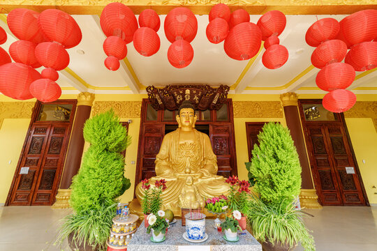 Gilded Buddha statue at Chua Tam An temple in Dalat, Vietnam