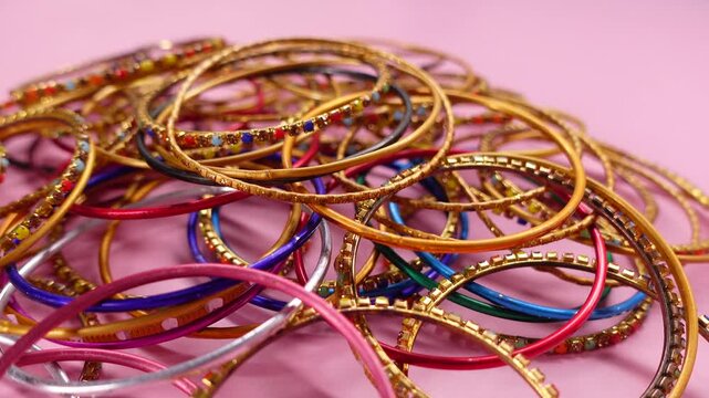 Colorful bangles on a pink background
