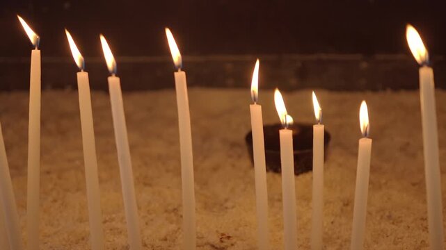 People light candles for a religious ceremony in a church