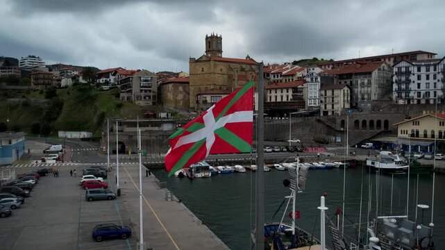 Basque Country flag in Getaria village, Spain. High quality 4k drone footage