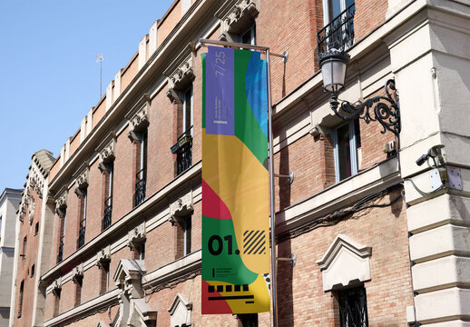 Mockup of a vertical fly banner on the facade of a building in Madrid.