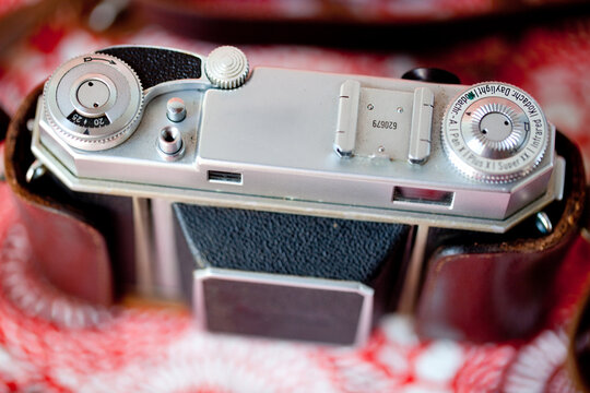 Vintage Camera Black with brown leather red background