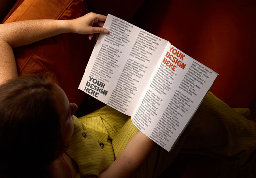 Mockup of female hands holding an open magazine with 2 pages