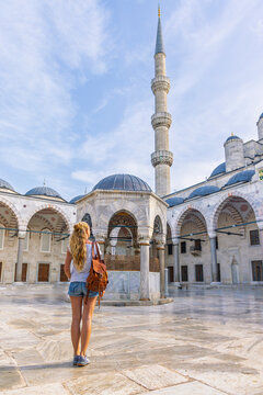 traveler woman exploring the courtyard of blue mosque in istanbul