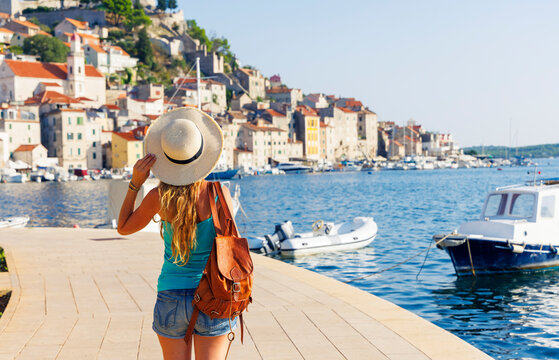 woman traveler with straw hat looking at sibenik old town in croatia