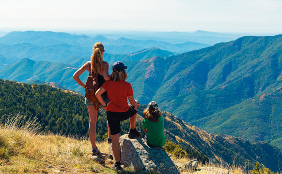 Family hiking enjoying mountain view from mont aigoual france