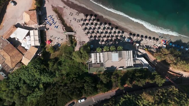 Aerial Top Down Drone Reveal from Coastal Villas to Turquoise Ermones Beach in Corfu Greece