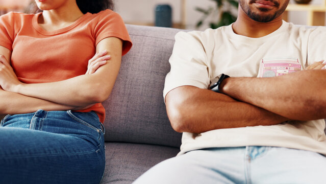 Crossed arms, couple and conflict in home, anger or tension with marriage problem on couch. Woman, man and risk of divorce with relationship dispute, drama or argument crisis on sofa at house