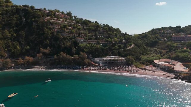 Aerial Drone Approach Over Crystal Clear Water to Ermones Beach and Coastal Resorts in Corfu Greece