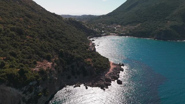 Aerial Panorama of Deep Blue Ionian Sea and Lush Green Hills of Ermones Bay in Corfu Greece