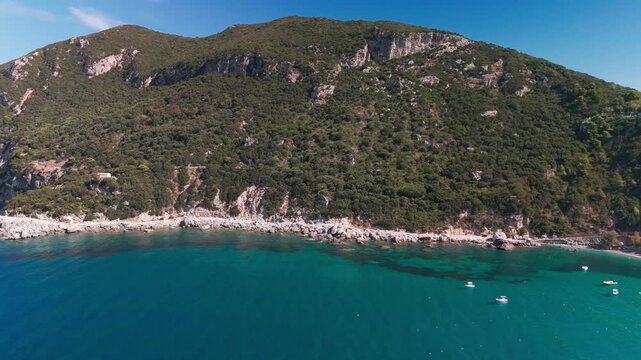 Aerial Panning View of Turquoise Ionian Sea and Rugged Coastline at Ermones Bay Corfu