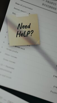 Tax form with a stick note over it with question Need Help