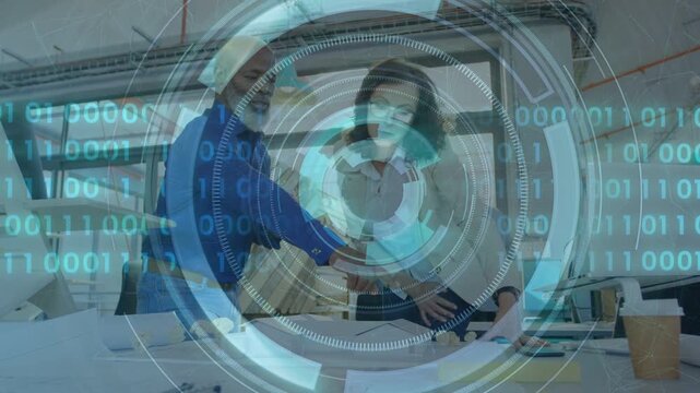 Man in blue pointing plans, woman tracing details at studio table, HUD responding, aligning design